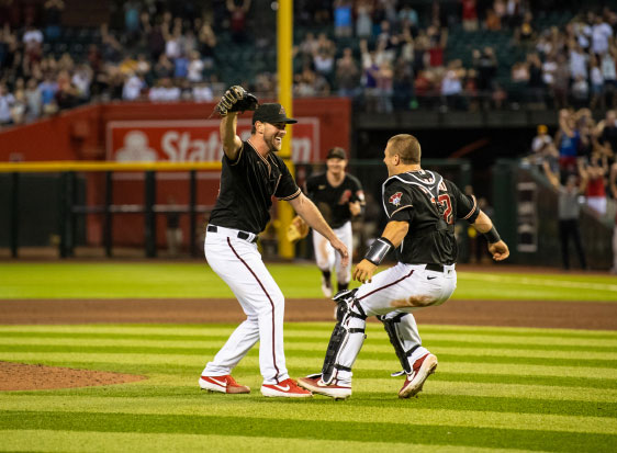 2 Diamondbacks players about to embrace in celebration