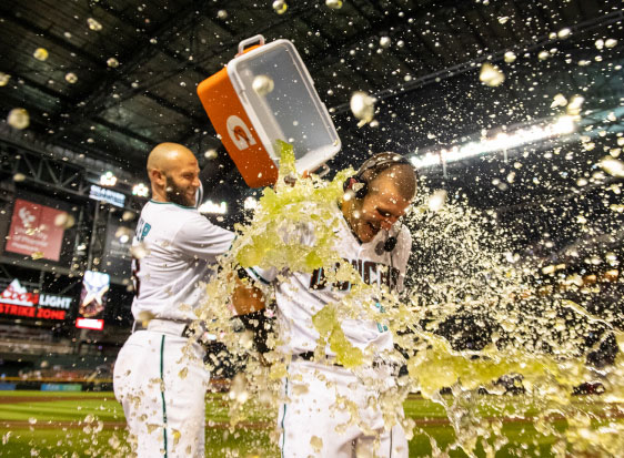 A player throws a cooler full of Gatorade on another player